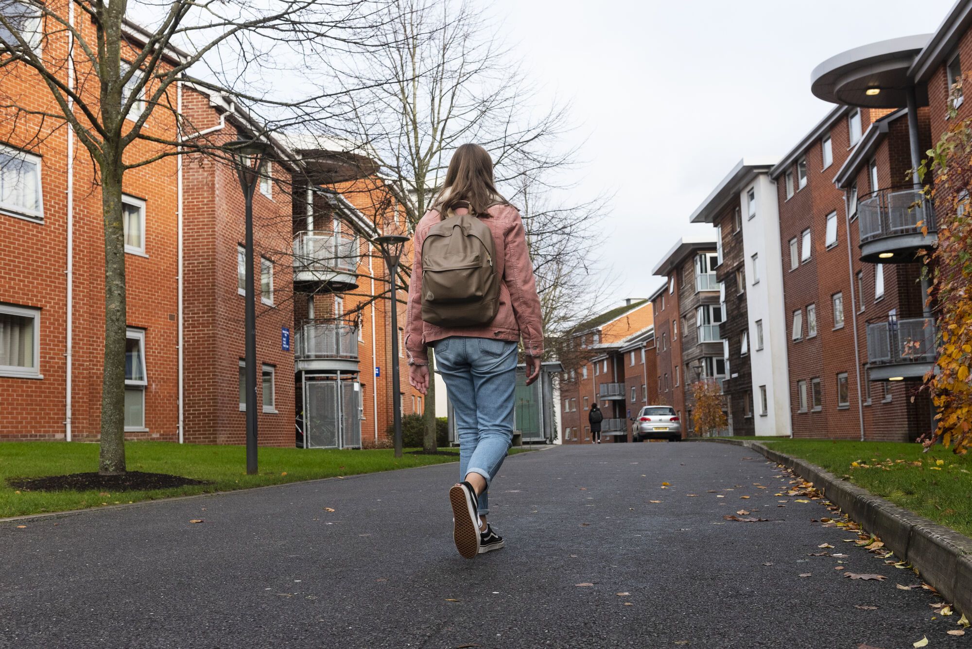A student walks through the accommodation on Manor Park