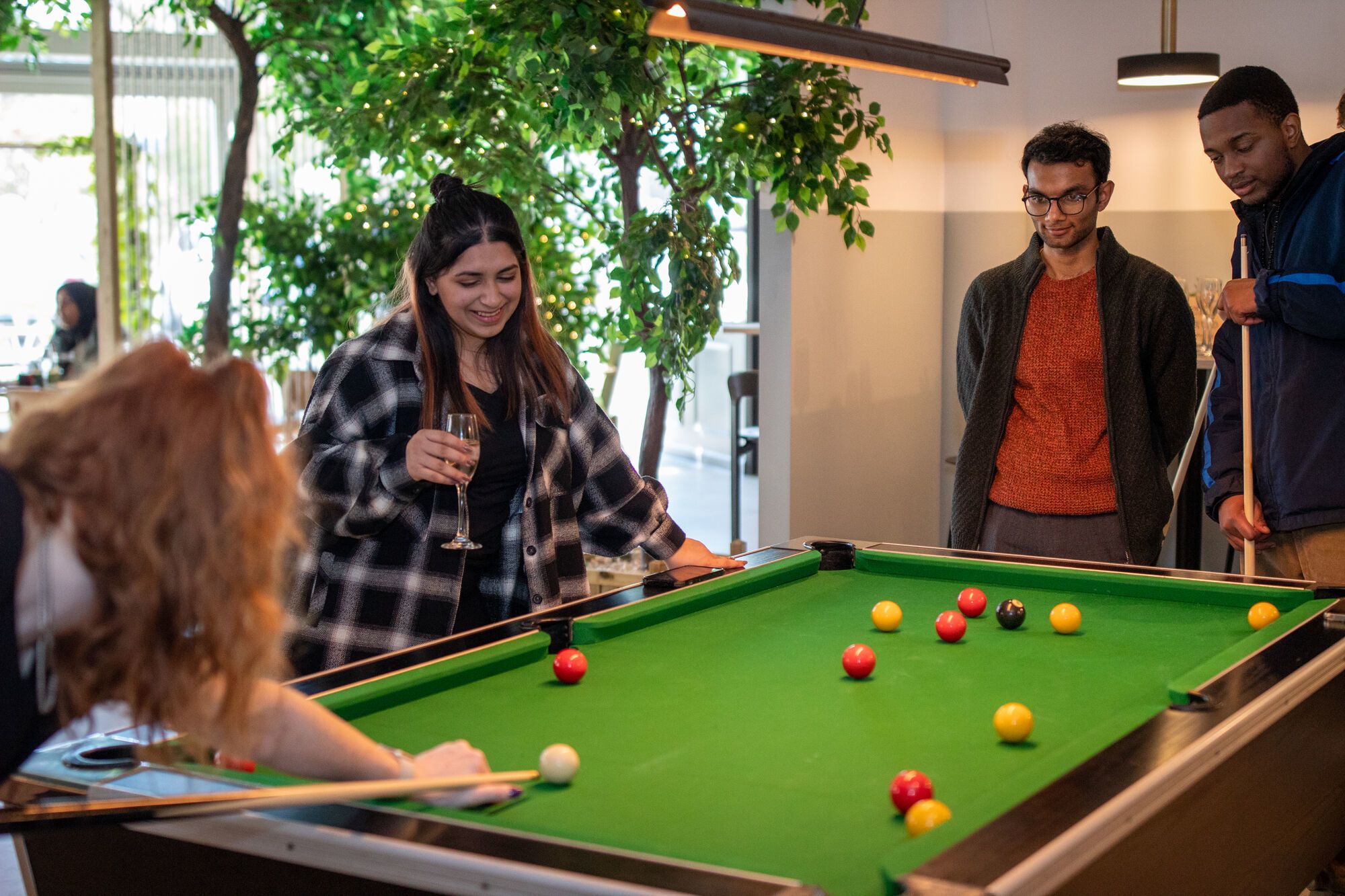 Students play pool in Manor Park Social